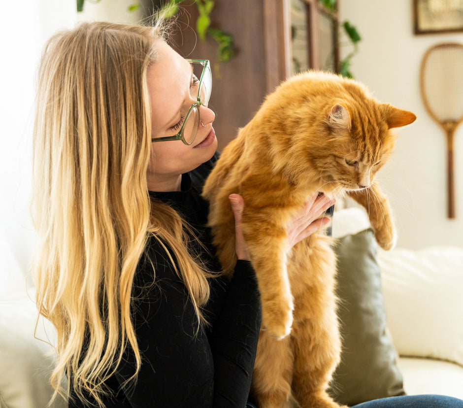 A lady holding a cat. 